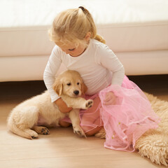 Child, golden retriever or dog playing together in a happy home with love, care and development. Girl kid and animal, puppy or pet in a tutu for dress up game as friends on the living room floor