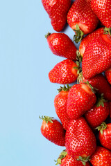 Fresh strawberries on blue background
