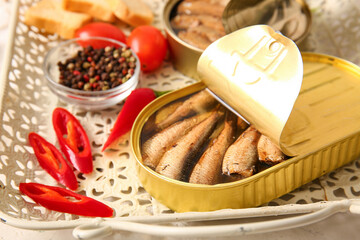 Tray of canned smoked sprats with tomatoes and chilli, closeup