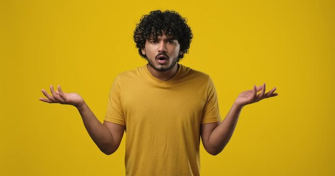 Frustrated indian man raising his hands and shrugging his shoulders with an indignant expression, asking the reason for the failure, showing disappointment, chagrin due to problems