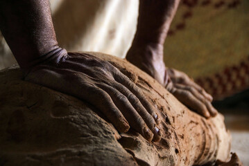 Close up hands of the traditional pottery making in the old way clay and Kneading and mashing the mud with hands and feet
