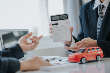 Up close shows the calculator for the cost of the car and the rental interest that must be paid. The car dealer or sales manager offers to sell the car and explains the terms of the car contract and i