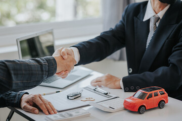 close handshake after signing a contract and paying successfully The car dealer or sales manager...