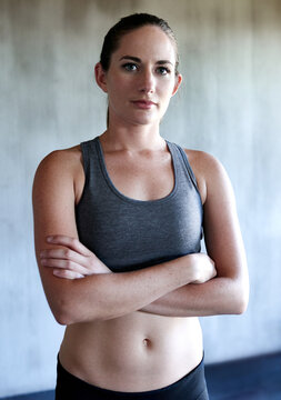 Workout, arms crossed and portrait of woman confident after health club exercise, fitness studio performance or gym training. Athlete lifestyle, motivation and healthy female person with confidence