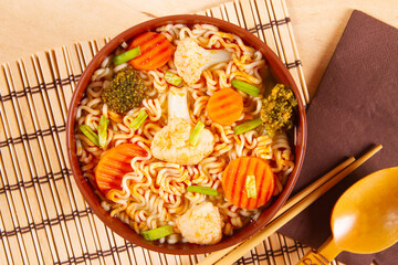 Clay bowl with veg meal. Curved Noodles with vegetables