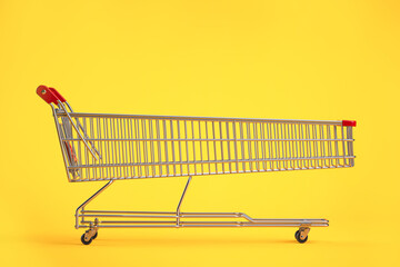 Long shopping cart on yellow background. Sales an discounts concept. © Maksym Yemelyanov
