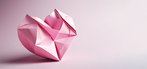 Pink origami heart on pink background