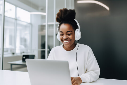 A confident black woman is hard at work on her laptop in a modern and bustling startup office, smiling with satisfaction at her progress. generative AI.