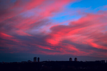 Fototapeta premium Sky over city at night with red dramatic clouds.
