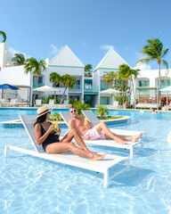 Luxury resort with swimming pool near Palm Beach Aruba Caribbean, couple man and woman mid age on a...