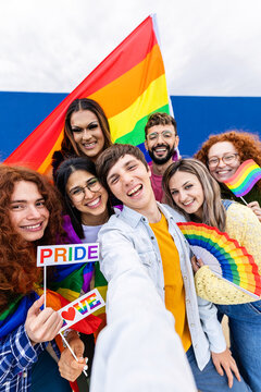 LGBTQ Community People Celebrating Gay Pride Day Festival Taking Vertical Selfie With Phone. Young Group Of Homosexual Men And Women Having Fun Together Outdoors. LGBTQI Concept.