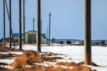 冬の北海道野付半島のあぜ道と電柱