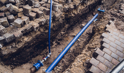 Big construction site with pipes and wires in the construction area.