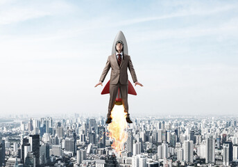Businessman in aviator hat flying on rocket