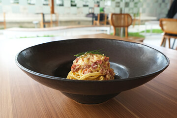 Spaghetti Carbonara, with eggs, parmesan cheese and cream sauce. Traditional Italian cuisine.
