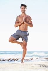 Fototapeta na wymiar Happy man, yoga and meditation in balance on beach for spiritual wellness, zen or tree pose in nature. Male yogi standing in namaste to meditate, relax or healthy body for inner peace by the ocean