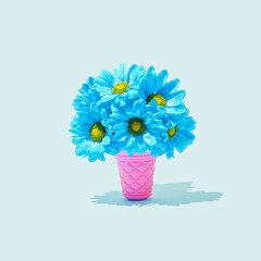Pink Ice Cream Cone with Bouquet of pastel blue Flowers. Spring Summer Floral style. Creative Minimal art. Trendy fashion ice cream flower concept.