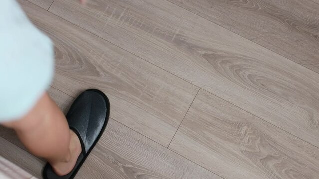 young woman puts on sleepers and going to kitchen, top view closeup cropped slow motion, girl dancing in the morning