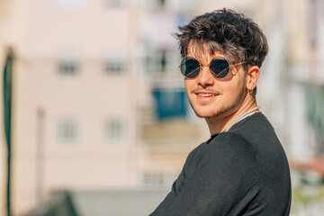 portrait of young male with sunglasses in the street
