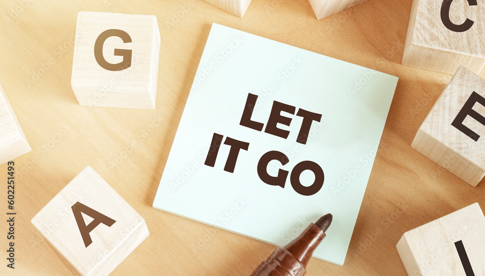 Poster sticker with text let it go in the middle of wooden cubes with letters