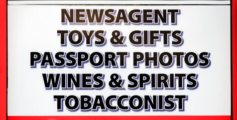 Newsagent shop sign selling toys, gifts, wines, tobacco