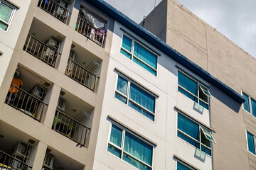 Modern condominium building window against blue sky