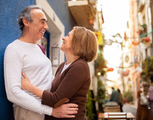 Joyful Mature European Couple Hugging Standing Outside On A Street