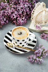  Lilac flowers  and  coffee mug   on   grey  background
