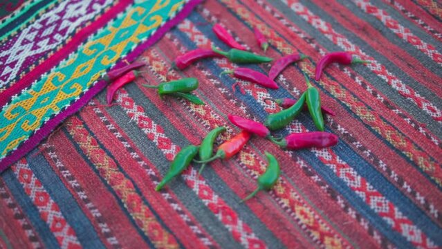 Hot peppers are thrown on a handmade carpet
