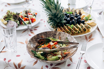 Served table food buffet in restaurant for wedding or birthday party dinner dishes. Assorted ananas, banana, grapes, fruits
