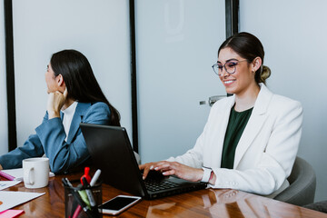 young latin business woman at work using laptop in at office in Mexico Latin America, hispanic...