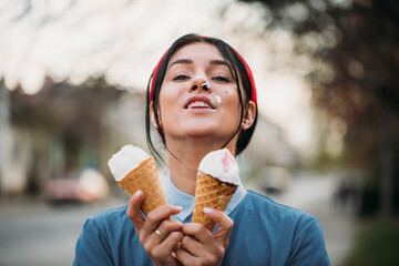 Young woman holding a cornet ice cream