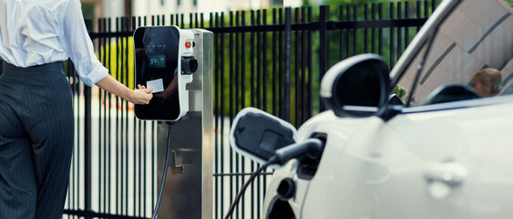 Credit card payment for eco-friendly clean and sustainable energy for electric vehicle at charging...