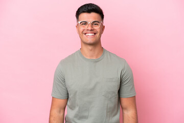 Obraz premium Young caucasian handsome man isolated on pink background laughing