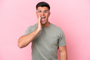 Young caucasian handsome man isolated on pink background with surprise and shocked facial expression