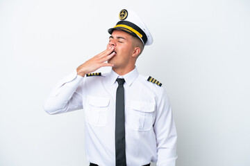 Airplane pilot caucasian man isolated on white background yawning and covering wide open mouth with hand © luismolinero
