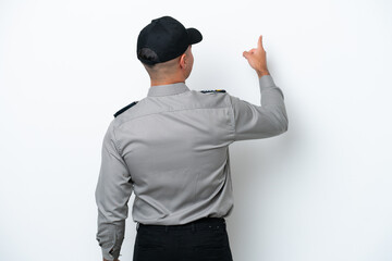 Young caucasian security man isolated on white background pointing back with the index finger