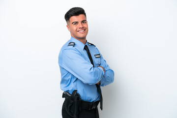 Young police caucasian man isolated on white background with arms crossed and looking forward