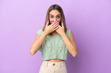 Young caucasian woman isolated on purple background covering mouth with hands
