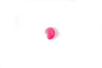 A drop of pink color, as a sample on a white background. Top view, flat lay