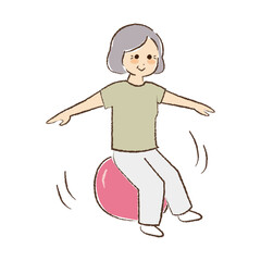 バランスボールに乗っている年配女性