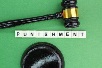 the judge's hammer with the word Punishment. the concept of punishment or being fined found guilty