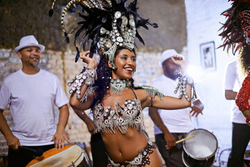 Carnival, dance and cultural female dancer performing with band at mardi gras or exotic festival....