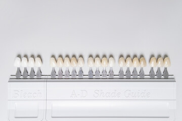 Close up of shade guide to check veneer of tooth crown in a dental laboratory. High quality flat lay photo. Top view