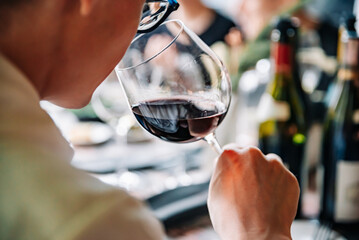 Man smelling a glass of red wine