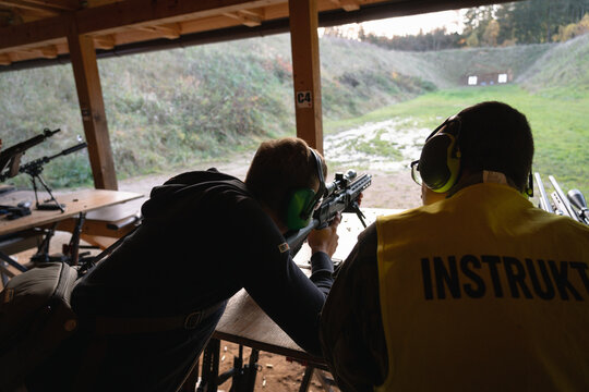 Training shooting weapons at an outdoor shooting range.
