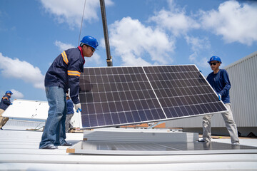 Asian mechanic checking roof solar panel maintenance A team of technicians installing solar panels...