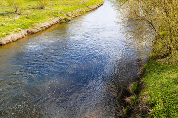 view of water of small river on sunny spring day