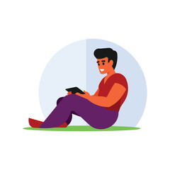 A man sitting on the grass with a book in his hand.