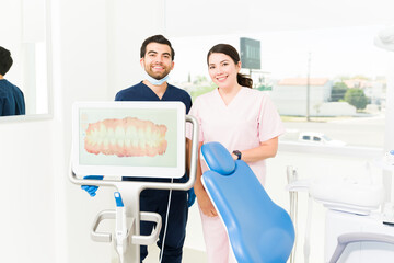Hispanic dentist and female dental assistant using 3d model technology